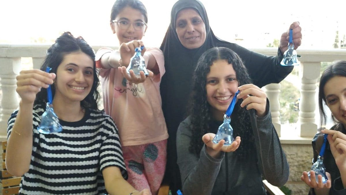 Bethlehem Fair trade artisans showing 2025 Christmas bauble collection.