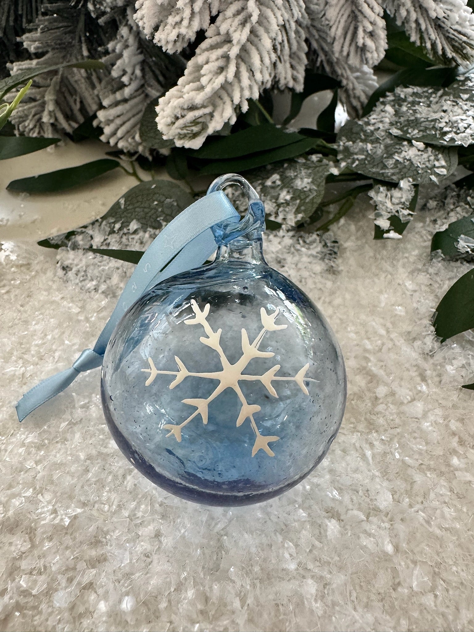 Christmas ornament made in Bethlehem from recycled glass featuring snowflake with blue dated ribbon